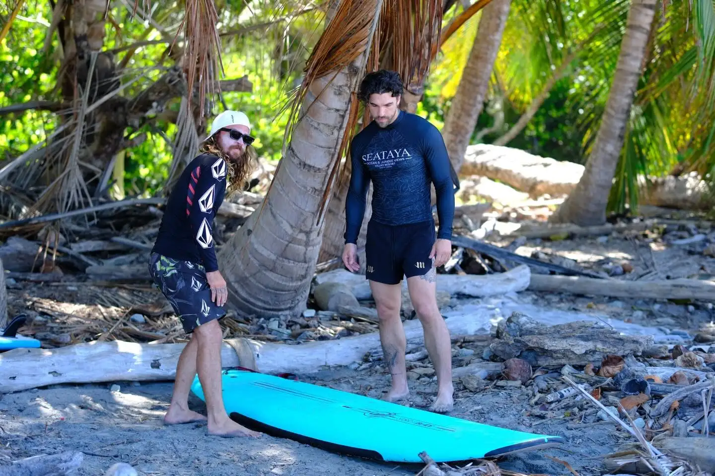 Professional surfer showing a student how to stand up on the board