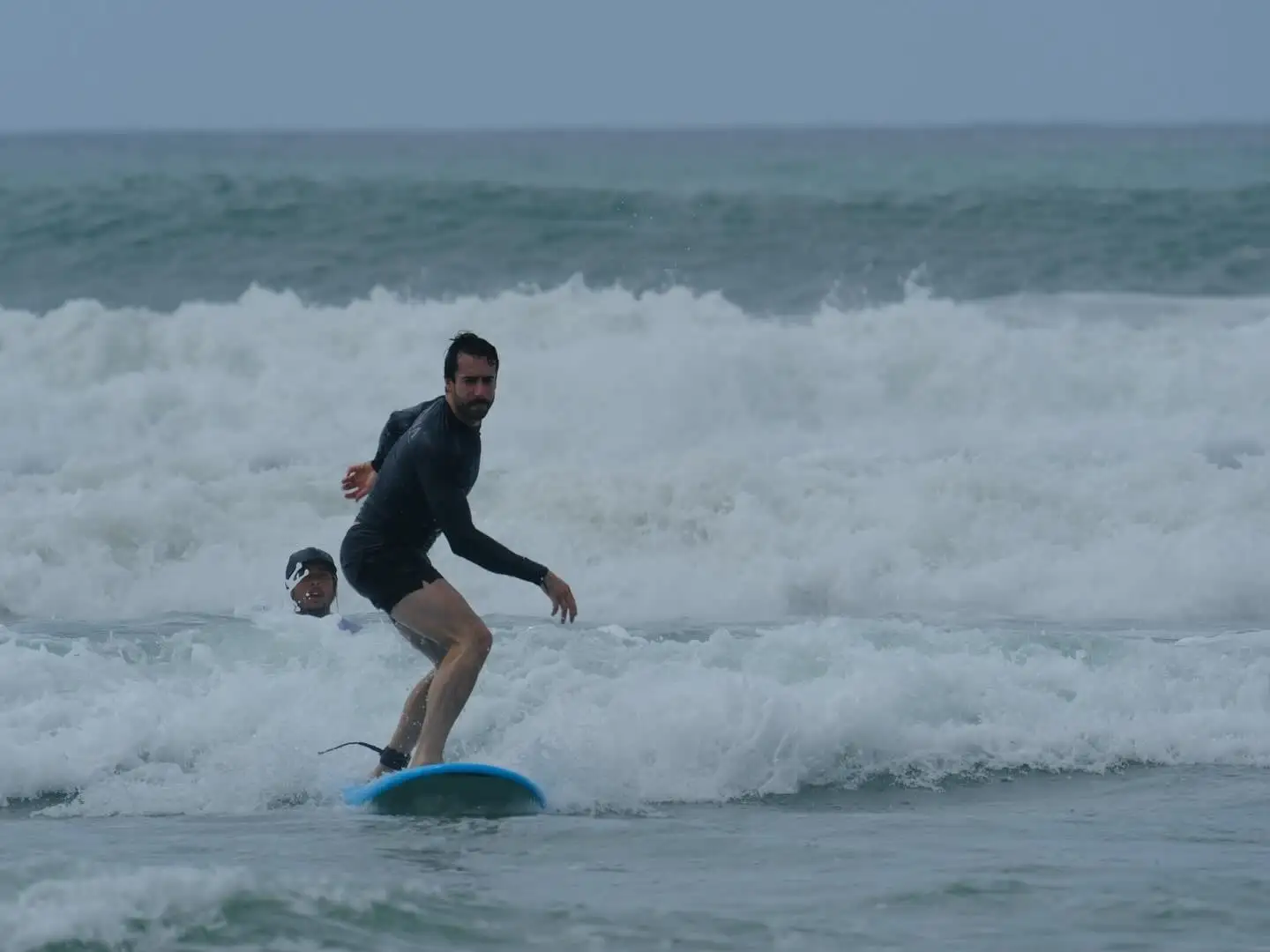 Student riding the whitewater on a soft-top board
